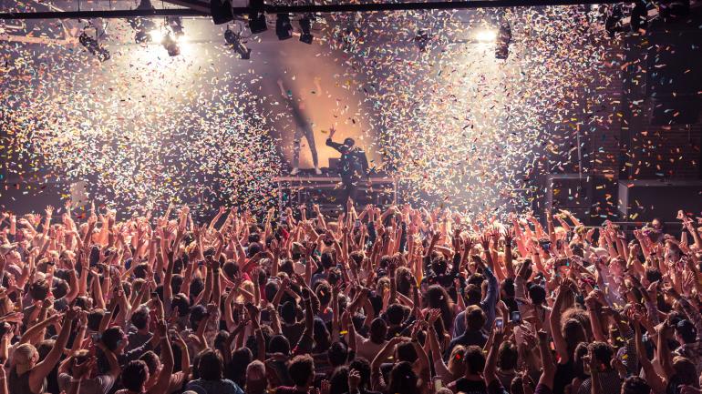 Confetti flying while the crowd dances during a concert at Iron City Confetti flying while the crowd dances during a concert at Iron City
