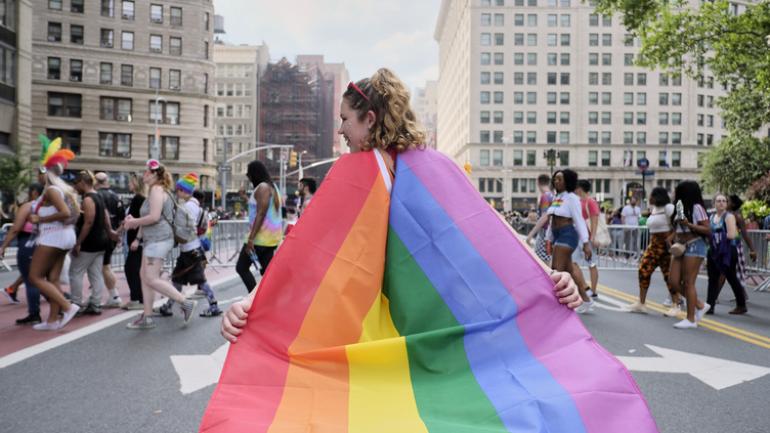 Girl in New York City with Pride flag Girl in New York City with Pride flag