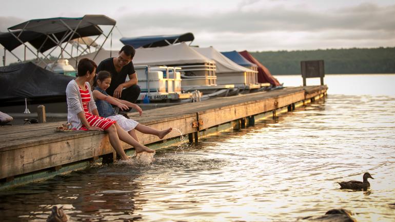 Family enjoying the sunset at Lake Wallenpaupack in the Pocono Mountains in Pennsylvania Family enjoying the sunset at Lake Wallenpaupack in the Pocono Mountains in Pennsylvania
