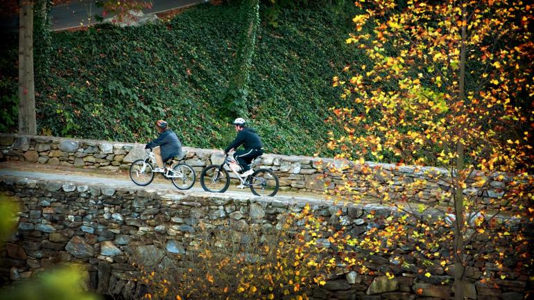 Riding bikes through Falls Park in Greenville, South Carolina Riding bikes through Falls Park in Greenville, South Carolina