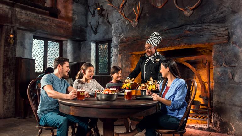 Family dining at the Three Broomsticks™ in The Wizarding World of Harry Potter™ Family dining at the Three Broomsticks™ in The Wizarding World of Harry Potter™