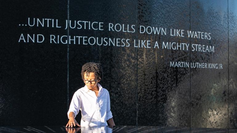 Boy studying the Civil Rights Memorial in Montgomery, Alabama Boy studying the Civil Rights Memorial in Montgomery, Alabama
