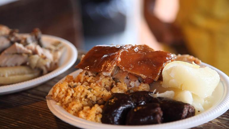 A plate of freshly roasted lechón and traditional sides from a restaurant on The Pork Highway A plate of freshly roasted lechón and traditional sides from a restaurant on The Pork Highway