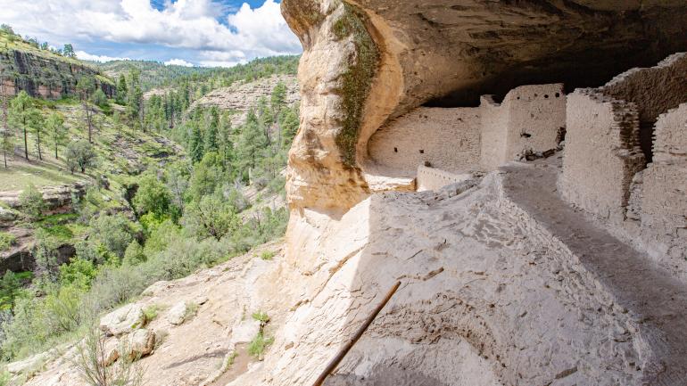 Cliff dwellings overlooking the rugged landscape of Gila Cliff Dwellings National Monument Cliff dwellings overlooking the rugged landscape of Gila Cliff Dwellings National Monument