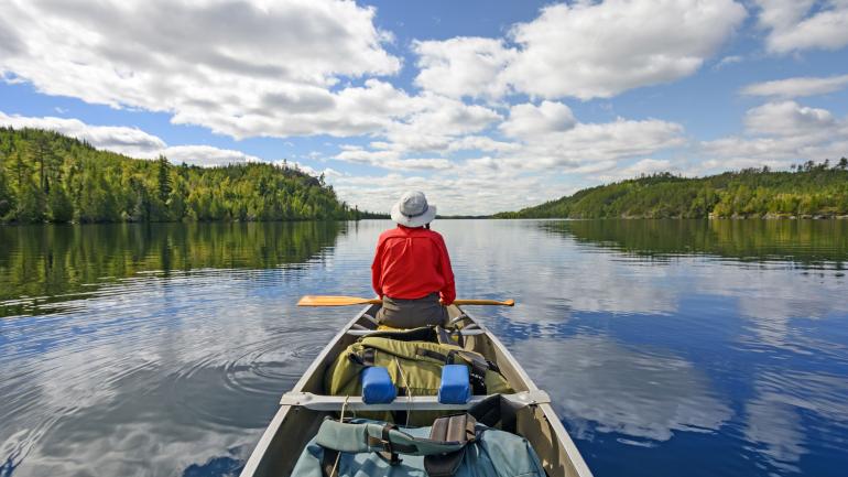 Taking a break from paddling to enjoy the tranquility of Kekekabic Lake in the Boundary Waters Taking a break from paddling to enjoy the tranquility of Kekekabic Lake in the Boundary Waters