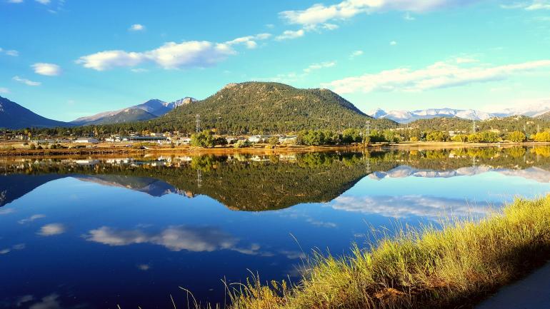 Blue skies and Rocky Mountain peaks reflecting in Lake Estes Blue skies and Rocky Mountain peaks reflecting in Lake Estes
