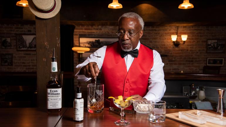 Louisville local George Harrison portraying Tom Bullock, the first Black American to write and publish a cocktail book, at the Evan Williams Bourbon Experience Louisville local George Harrison portraying Tom Bullock, the first Black American to write and publish a cocktail book, at the Evan Williams Bourbon Experience
