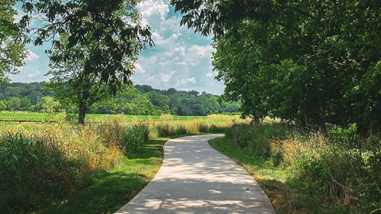 A paved path winding through the Parklands of Floyds Fork A paved path winding through the Parklands of Floyds Fork