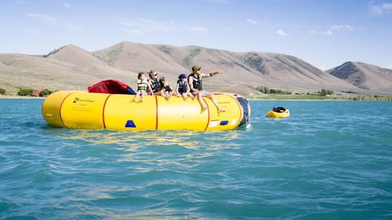 Family fun on a water trampoline in Bear Lake State Park, Idaho Family fun on a water trampoline in Bear Lake State Park, Idaho