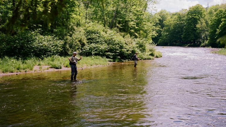 Fly fishing a mountain stream in the Catskill Mountains in New York State Fly fishing a mountain stream in the Catskill Mountains in New York State