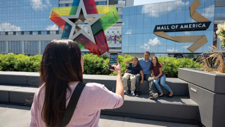 Family posing for a photo outside Mall of America in Bloomington, Minnesota Family posing for a photo outside Mall of America in Bloomington, Minnesota
