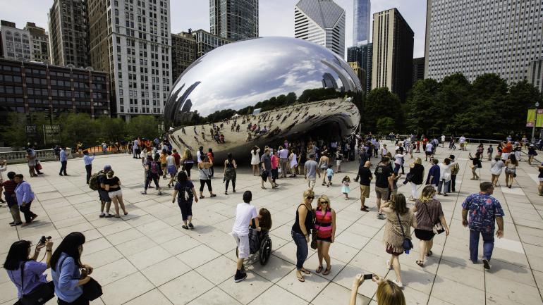 Posing for a photo in front of The Bean in Millennium Park in Chicago, Illinois Posing for a photo in front of The Bean in Millennium Park in Chicago, Illinois