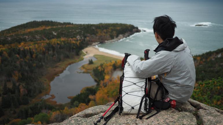 Hiker taking in the view at Acadia National Park, Maine Hiker taking in the view at Acadia National Park, Maine