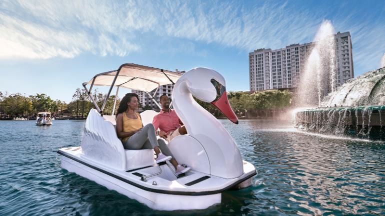 Pedaling a swan boat around Lake Eola in the core of Downtown Orlando Pedaling a swan boat around Lake Eola in the core of Downtown Orlando