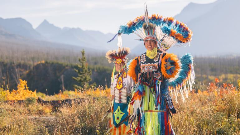 Blackfeet dancers dressed up in authentic tribal attire in the Montana wilderness Blackfeet dancers dressed up in authentic tribal attire in the Montana wilderness