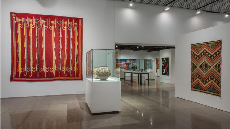 Displays of colorful textiles and pottery inside the historic Heard Museum Displays of colorful textiles and pottery inside the historic Heard Museum