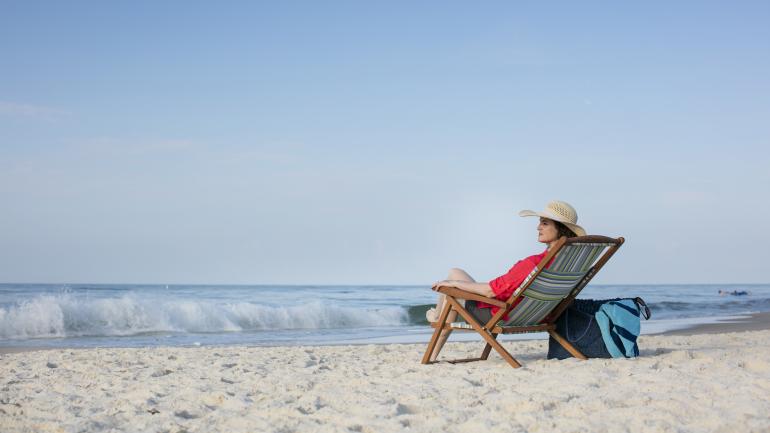 Relaxing in a beach chair on the white sands of Gulf Shores, Alabama Relaxing in a beach chair on the white sands of Gulf Shores, Alabama