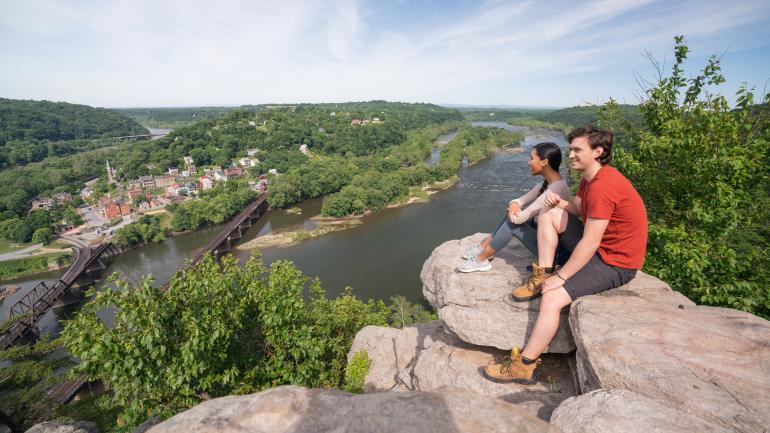 Hikers at Maryland Heights Trail overlook above Harpers Ferry, West Virginia Hikers at Maryland Heights Trail overlook above Harpers Ferry, West Virginia