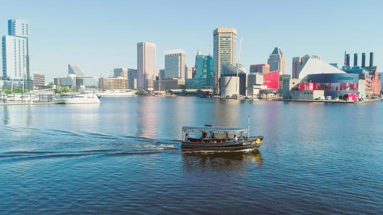 A water taxi cruising around the Inner Harbor in Baltimore, Maryland A water taxi cruising around the Inner Harbor in Baltimore, Maryland