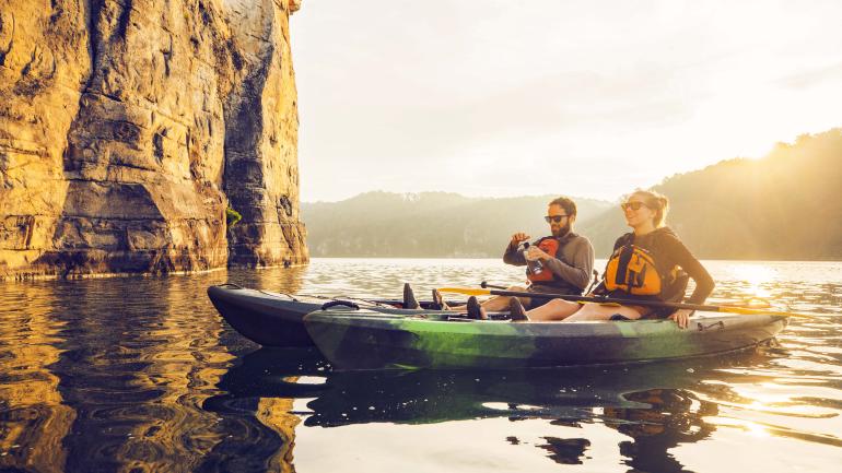 Two kayakers enjoy cliff views at sunset in Summersville, West Virginia Two kayakers enjoy cliff views at sunset in Summersville, West Virginia