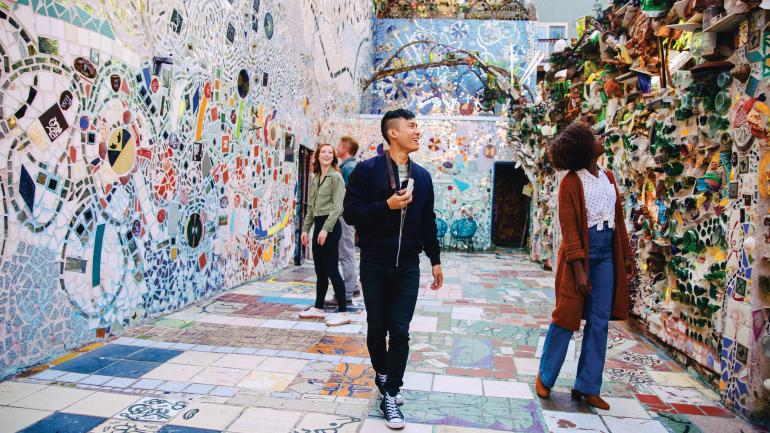 Visitors to Philadelphia’s Magic Gardens enjoying the quirky installation Visitors to Philadelphia’s Magic Gardens enjoying the quirky installation