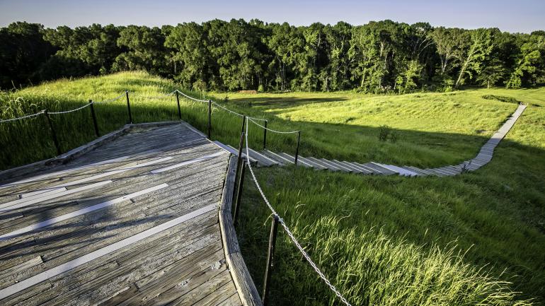 A walkway winds through ancient earthen mounds at Poverty Point World Heritage Site near Pioneer A walkway winds through ancient earthen mounds at Poverty Point World Heritage Site near Pioneer
