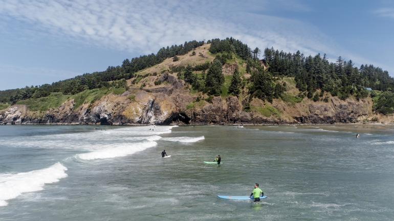 Surfers enjoy the waves at Agate Beach in Newport, Oregon Surfers enjoy the waves at Agate Beach in Newport, Oregon