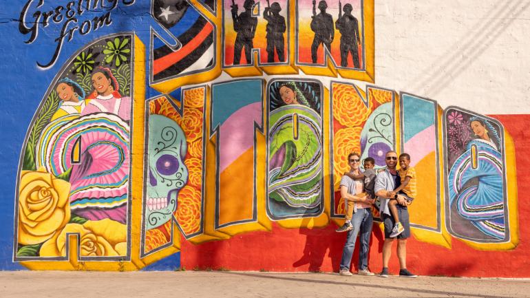 Family posing in front of a colorful mural in San Antonio, Texas Family posing in front of a colorful mural in San Antonio, Texas