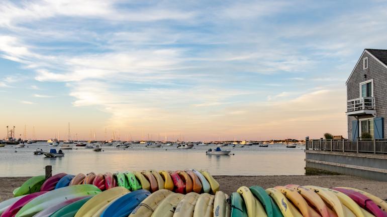 Kayaks line a Nantucket wharf at sunset Kayaks line a Nantucket wharf at sunset