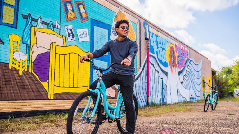 Biking past colorful murals in downtown Lake Charles Biking past colorful murals in downtown Lake Charles