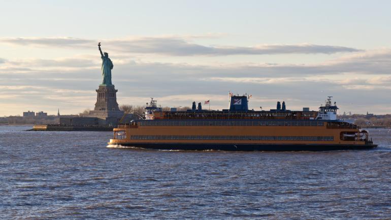 The Staten Island Ferry cruising past the Statue of Liberty The Staten Island Ferry cruising past the Statue of Liberty
