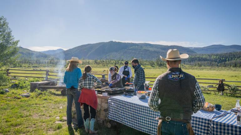 Guests enjoying a cookout on a Colorado dude ranch Guests enjoying a cookout on a Colorado dude ranch