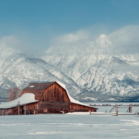 Snowy Wyoming farm with the Grand Tetons in the background