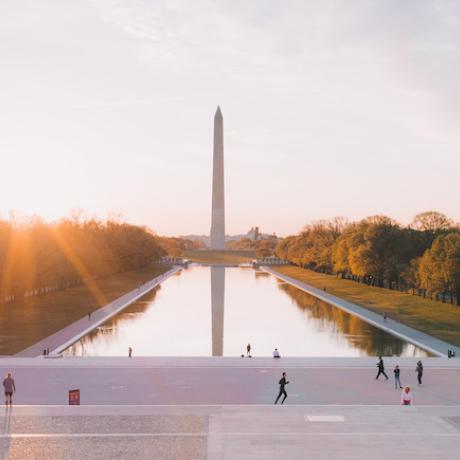 Sun shining over the National Mall with the Washington Monument in the background in Washington D.C.