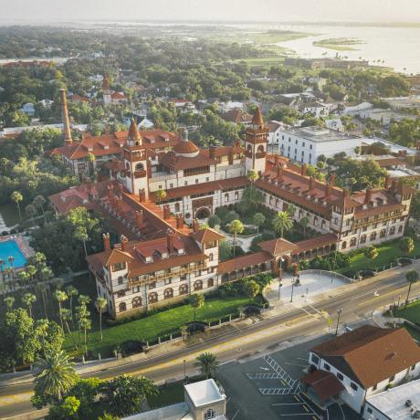 Aerial view of Flagler College with Castillo de San Marcos in the background in St. Augustine, Florida