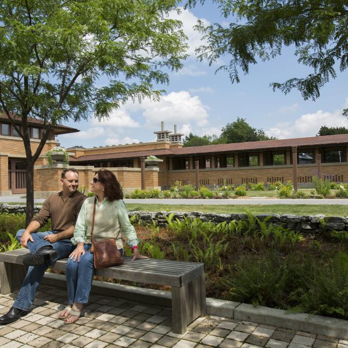 A couple sits outside Martin House, designed by Frank Lloyd Wright A couple sits outside Martin House, designed by Frank Lloyd Wright