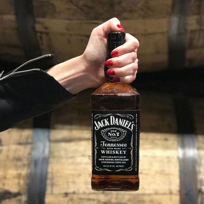Showing off a bottle of locally made Jack Daniels Tennessee Whiskey Showing off a bottle of locally made Jack Daniels Tennessee Whiskey