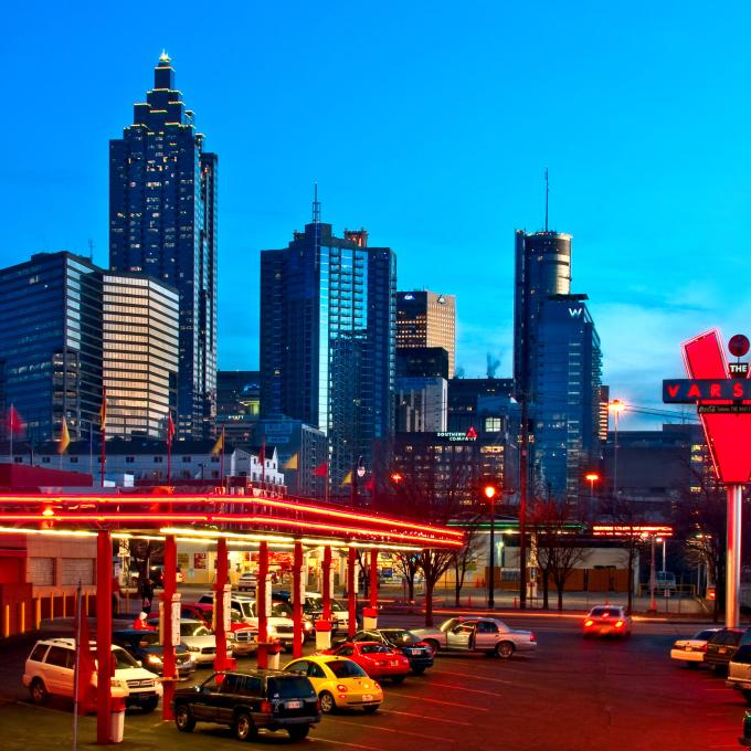 The Varsity drive-in restaurant and its neon lights glowing against the downtown Atlanta, Georgia, skyline The Varsity drive-in restaurant and its neon lights glowing against the downtown Atlanta, Georgia, skyline