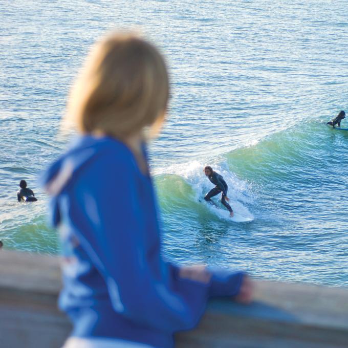 Watching surfers ride the waves from the Westgate Cocoa Beach Pier in Florida Watching surfers ride the waves from the Westgate Cocoa Beach Pier in Florida