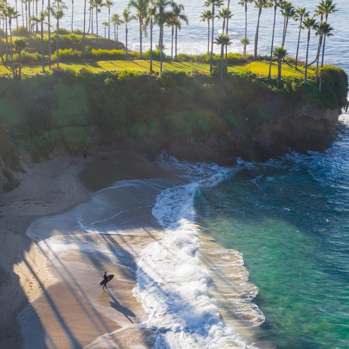 Aerial view of a surfer in Shaws Cove in Laguna Beach, California Aerial view of a surfer in Shaws Cove in Laguna Beach, California