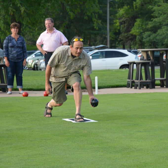 Bowler preparing to roll his jack down the green at Brookview Golf & Lawn Bowling in Golden Valley, Minnesota Bowler preparing to roll his jack down the green at Brookview Golf & Lawn Bowling in Golden Valley, Minnesota