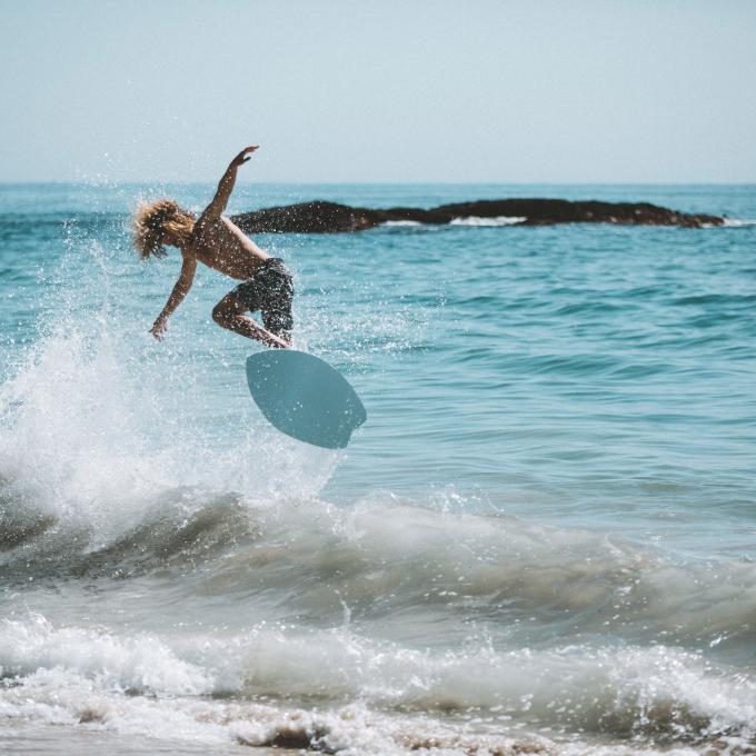 A skimboarder catching air in Laguna Beach, California A skimboarder catching air in Laguna Beach, California