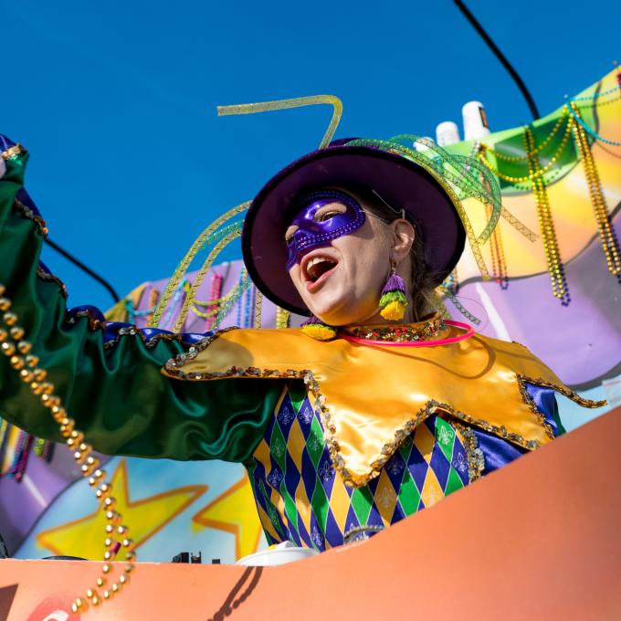 Tossing beads from the Krewe of Gemini float during a Mardi Gras parade in New Orleans, Louisiana Tossing beads from the Krewe of Gemini float during a Mardi Gras parade in New Orleans, Louisiana