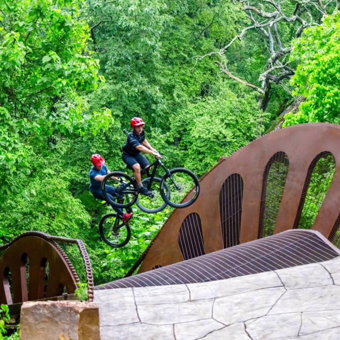 Cyclists ride The Masterpiece at the Crystal Bridges Museum of American Art in Bentonville, Arkansas Cyclists ride The Masterpiece at the Crystal Bridges Museum of American Art in Bentonville, Arkansas