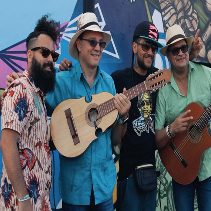 Street artists and musicians posing in front of a Miami, Florida, mural