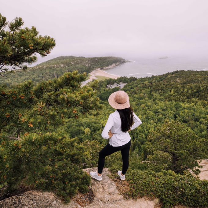A hiker overlooking the coast of Maine