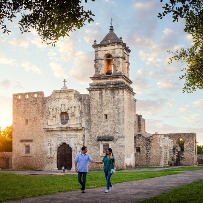 Couple strolling the grounds of Mission San Jose in San Antonio, Texas