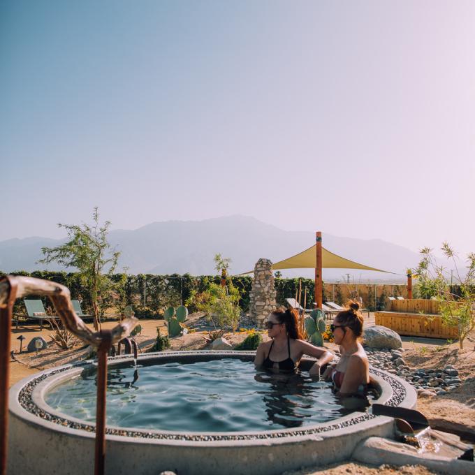 Soaking it a hot tub surrounded by desert landscapes near Palm Springs, California