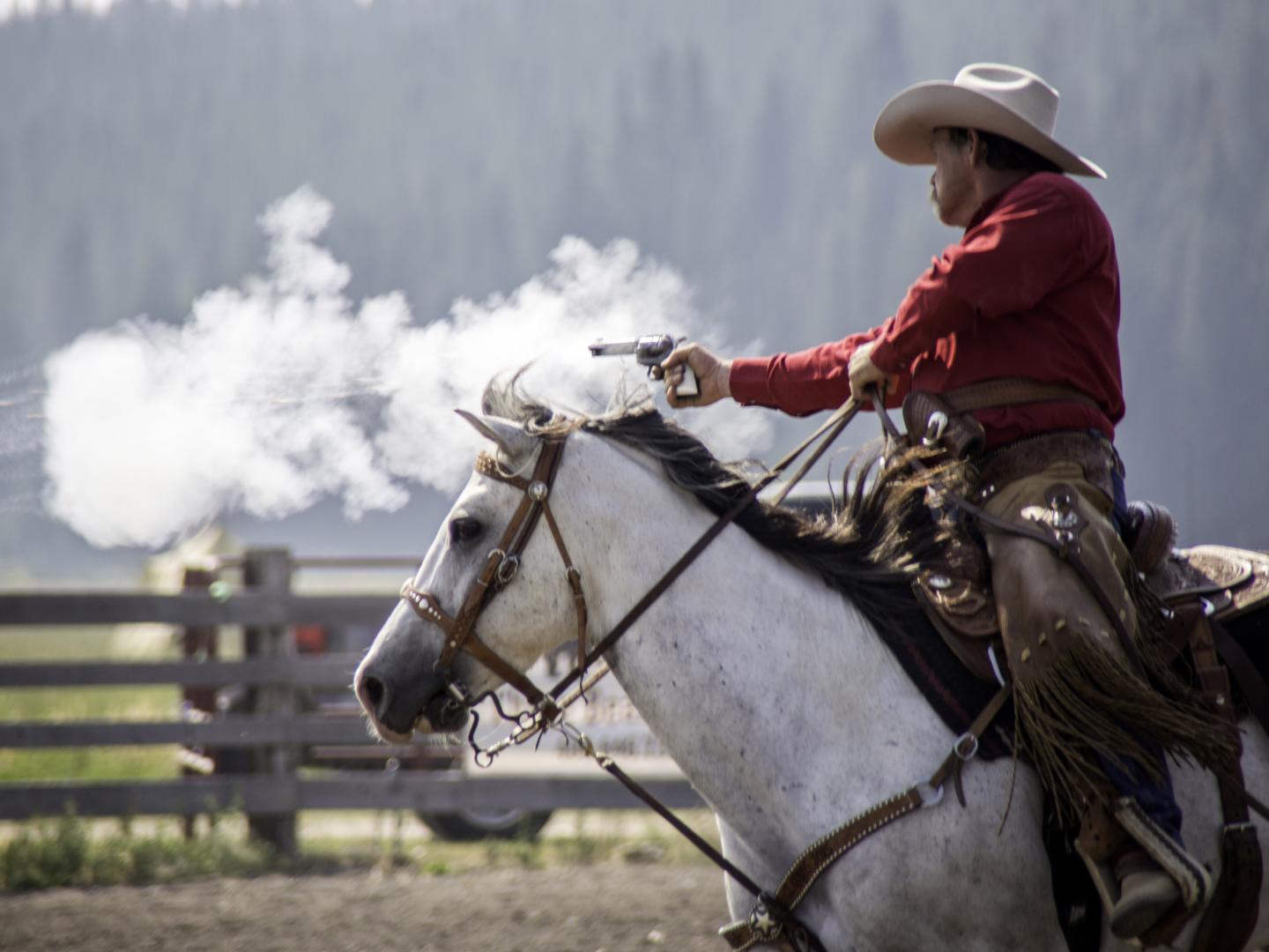 A cowboy in the Diamond P Cowboy Mounted Shooting Competition in West Yellowstone, Montana A cowboy in the Diamond P Cowboy Mounted Shooting Competition in West Yellowstone, Montana