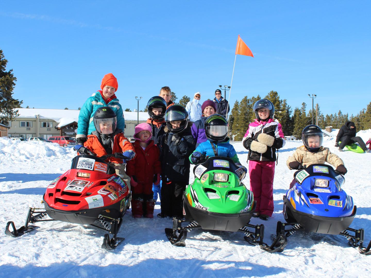 Family-friendly snowmobiling during KidsNSnow Weekends in West Yellowstone, Montana Family-friendly snowmobiling during KidsNSnow Weekends in West Yellowstone, Montana